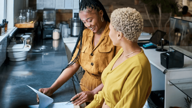 two women, looking at screen