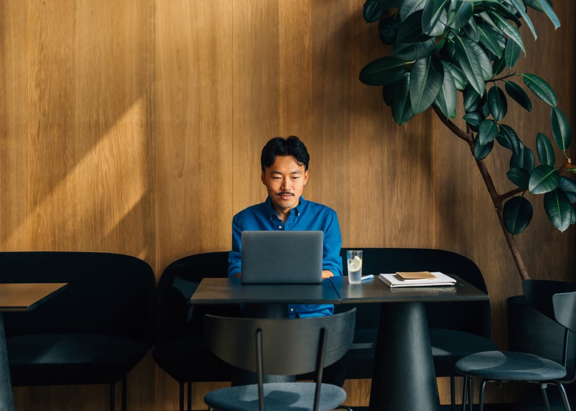 man working on his laptop in a cafe
