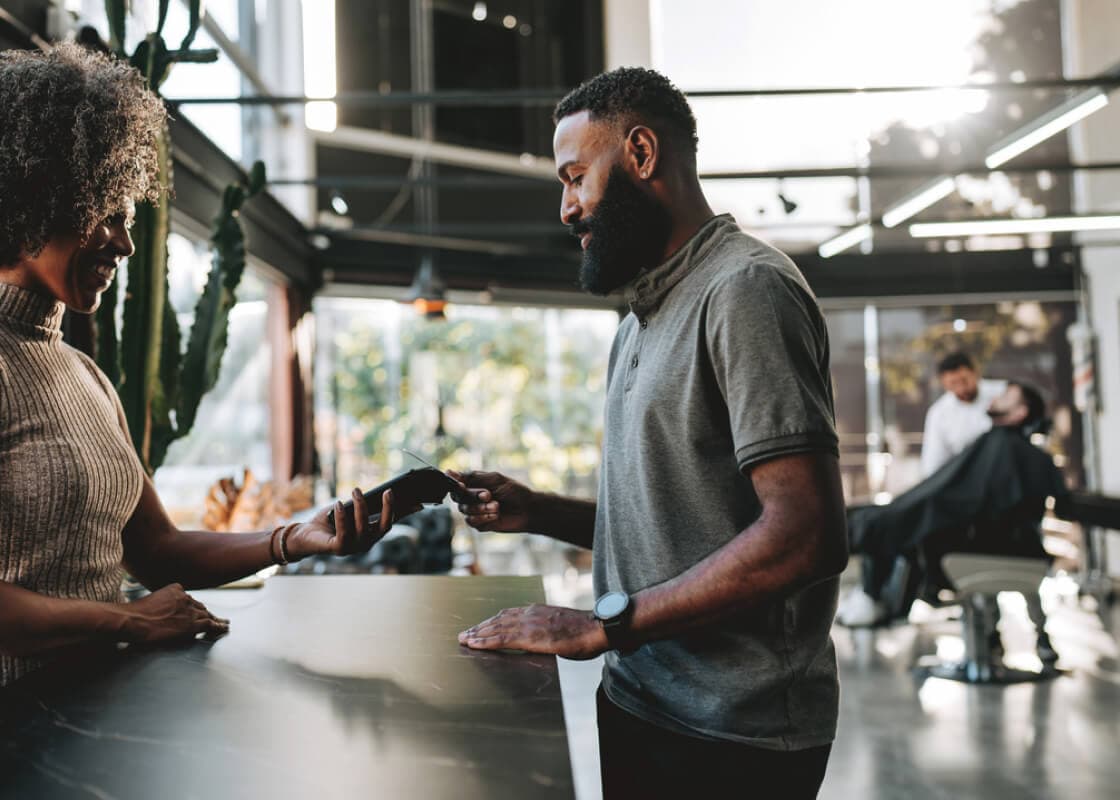 man paying at the barbershop